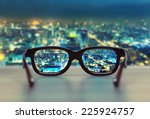 Night cityscape focused in glasses lenses