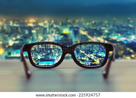 Night cityscape focused in glasses lenses