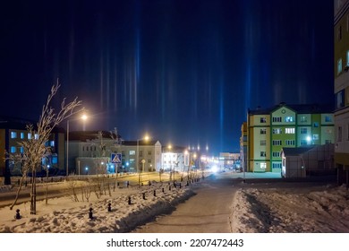 Night cityscape. View of a snow-covered street in the northern city. Bright pillars of light in the frosty sky. Cold winter weather. City of Anadyr, Chukotka, Siberia, Far North of Russia. Arctic. - Shutterstock ID 2207472443
