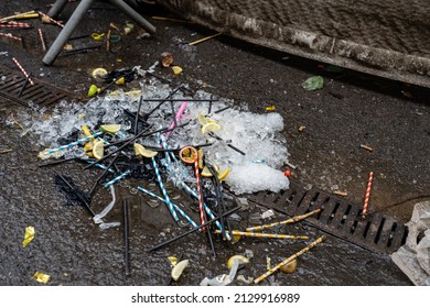 night club rubbish plastic straws lemon and lime wedges and ice cubes left on the floor outside after the night before - Shutterstock ID 2129916989