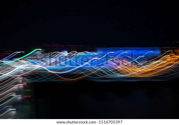 Night colorful lights abstract background,
Bright colored light curved lines. The concept of the future,
technology, progress.