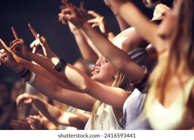 Night, concert and fans dance to music, performance and audience with energy at festival. Crowd, support and people stretching hands in celebration or praise of rock, culture or excited at event - Powered by Shutterstock