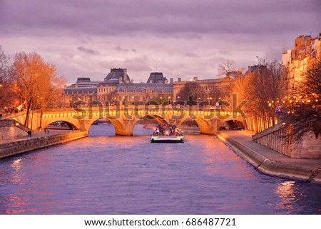 Night cruising on Sena river. Paris, France.