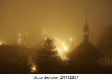 Night Czech town city Louny church spruce tree, street lights lamps in fog mist and haze, darkness mysterious moody atmosphere christmas xmas time - Powered by Shutterstock