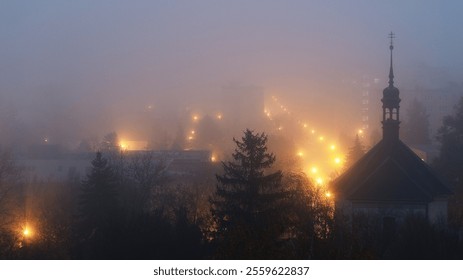 Night Czech town city Louny church spruce tree, street lights lamps in fog mist and haze, darkness mysterious moody atmosphere christmas xmas time - Powered by Shutterstock