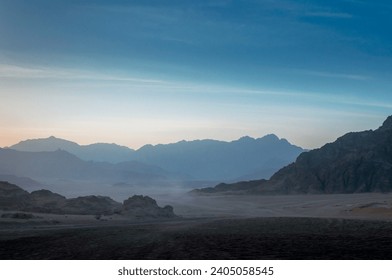 night desert landscape with rocky mountains and sunset sky with clouds in Sharm El Sheikh Egypt - Powered by Shutterstock