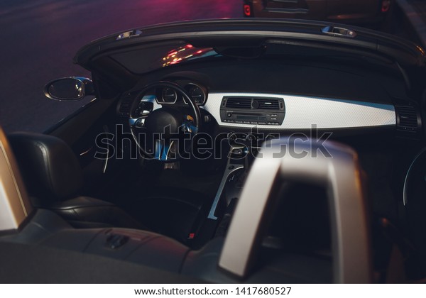 night driving a\
convertible with the top\
down.