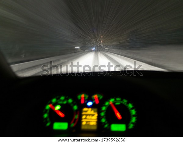 Night\
driving through the blizzard with colorful dasboard lights on\
resembles of a space ship entering hyper\
space.
