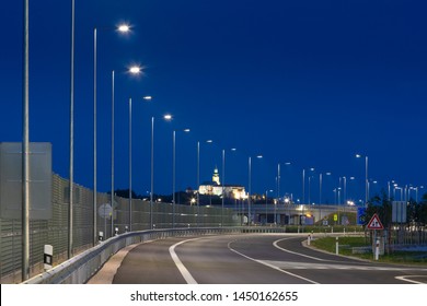 Night Empty Road With Modern LED Street Light And Noise Barrier