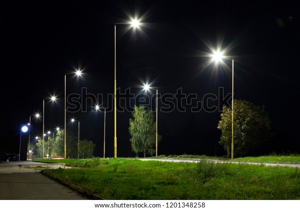 night empty road with modern LED street lights,\
entrance to a sm