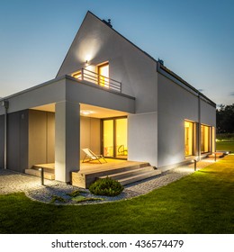 Night external view of a contemporary house with outdoor lighting