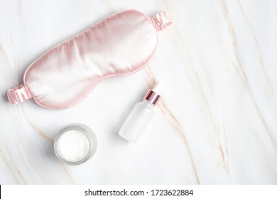 Night Face Care Routine Concept. Flat Lay, Top View Sleeping Mask, Moisturizer Cream, Serum Lotion On Marble Table. Facial Skin Care, Beauty Treatment Concept