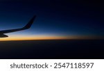 Night flight in reddish sky. Airbus under sky in Dim Lights, blur background and cloudy Atmosphere.