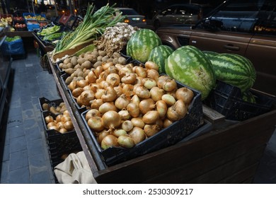 Night fruit and vegetable market. Crates filled with fresh products. Onions, watermelons, green onions, and potatoes. Vibrant street market atmosphere. Local grocery store background. - Powered by Shutterstock