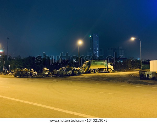 night garbage truck under the lights - Hanoi,\
Vietnam, March 16, 2019
