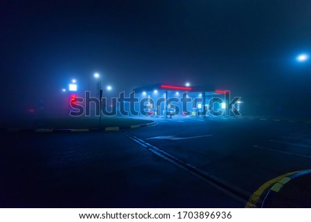 Night gas station in the fog