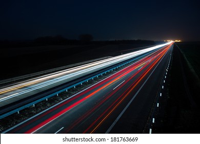Night highway with car traffic and blurry lights when long exposure