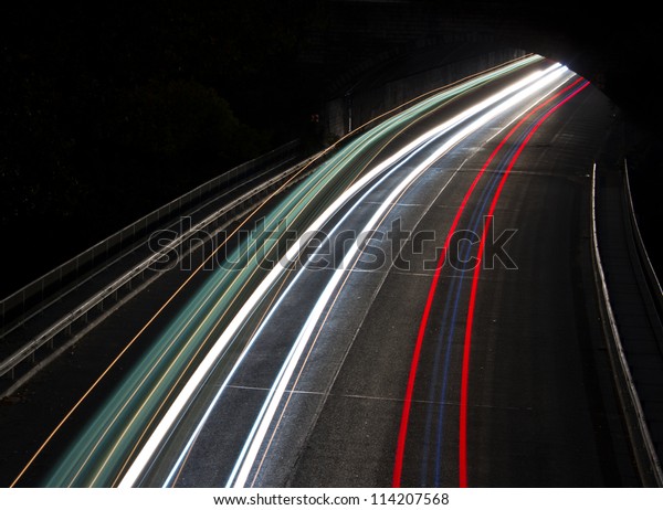 Night highway (Cars in a rush moving fast on a\
highway (speedway)
