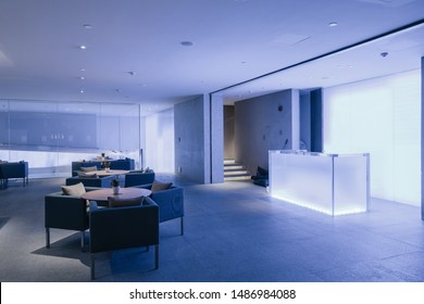 Night Hotel lobby interior with reception desk, sofas, and long bar.