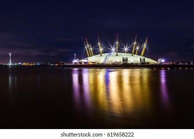 Night illumination of Millennium Dome, also called O2 Arena, in the distance across the river Thames. View from Canary Wharf. London, UK. November, 2012.