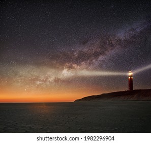Night image of the Texel lighthouse serving as a navigation beacon for ships with starry nightsky with Milky way galactic core - Shutterstock ID 1982296904