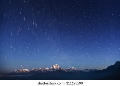 Night Laconic Landscape. Starry Sky Over The Snowy Mountains. 