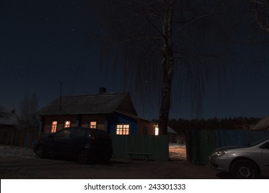 Night Landscape With Cozy Country House And The Car Was Standing Near