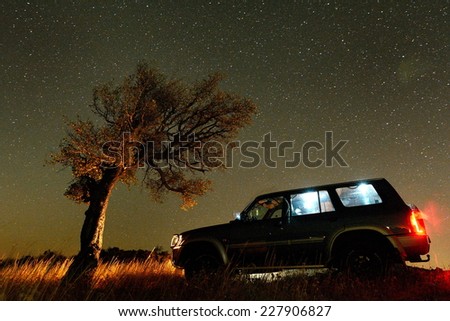 Night landscape on field and terrain car