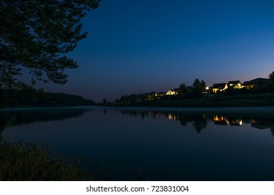 a night landscape, a pond in the village on the eve of dawn. quiet water. night walk - Powered by Shutterstock