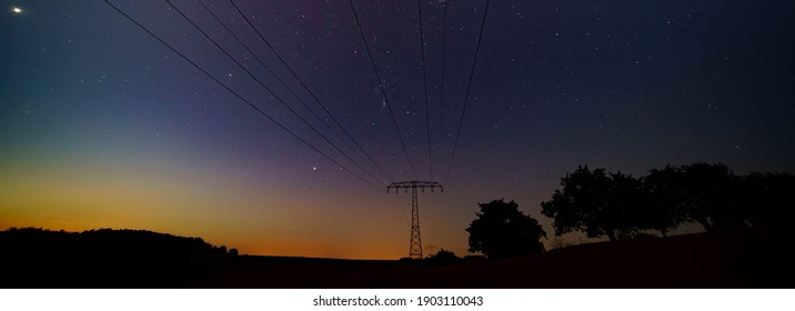 Night landscape with power lines on the starry sky