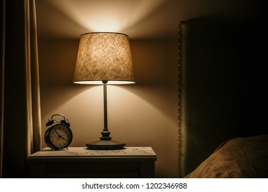 Night Light And Alarm Clock On The Bedside Table