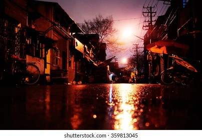 The Night Light Reflection On A Wet Asphalt In Shanghai Slums
