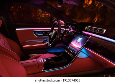 Night lighting cabin of luxury Mercedes S Class finished with real wood and leather and a huge multimedia screen MBUX. Rainy night. Katowice,Poland - 02.02.2021