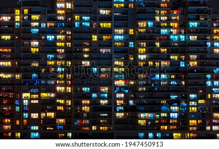 Night lights of a huge apartment. Living in a big city.