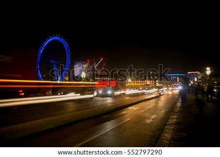 Night lights at London Eye from the river Thames