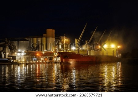 Night loading of grain into a cargo ship
