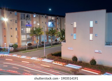 A Night Long Exposure Shot Of A Firetruck In Middle Of A Suburb Negborhood With Waning Crescent Moon In Sky. Urban Concept