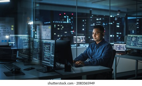 Night Office: Portrait Of Handsome Indian Man In Working On Desktop Computer. Digital Entrepreneur Typing, Creating Modern Software, E-Commerce App Design, Programming. Stylish Authentic Person