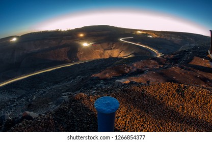 
Night Over The Coal Cut. Mine Under The Stars. View From Above. Starry Sky And Heavy Machinery. Work At Night. Big Cars. Beautiful Night Landscape Open Cut.