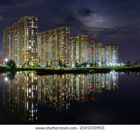 Night panorama with modern houses with reflection over the lake