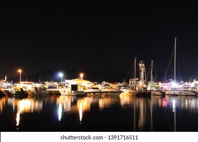 Night parking of yachts in the Croatian ACI marina of the town of Jazira. Burning lights of the evening Mediterranean port with sailing yachts and fishing boats. Twilight on the Adriatic Riviera. Calm - Powered by Shutterstock