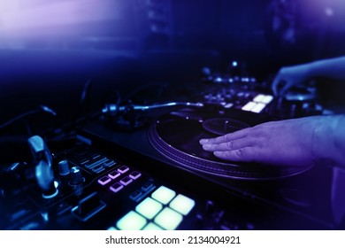 Night party with scratch dj playing vinyl, turntable deck with mixer controller, headphones. Nightlife concept background