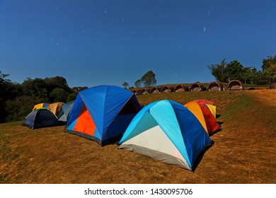 Night Photography Of Many Camping Tents Under The Stars In The During The Light Of The Full Moon And The Beautiful Nature, Doi Samur Dao, Sri Nan National Park, Nan Province, Northern Of Thailand