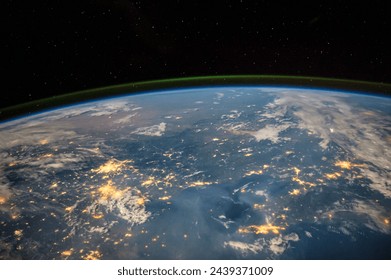 Night photography taken from the International Space Station showing China and Aurora lights from a wide angle. Long exposure reveals distant stars as well. Elements of this image furnished by NASA - Powered by Shutterstock