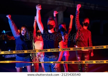 Night of riot. Group of protesting young people that standing together. Activist for human rights or against government.