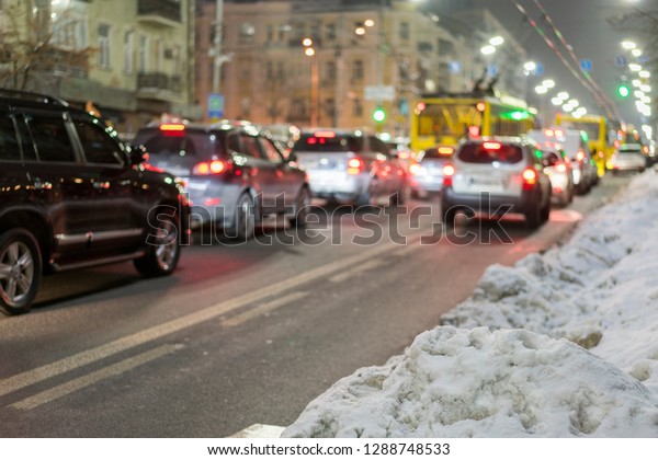 Night road in the city of lights cars traffic jams.\
Winter traffic in the\
city.