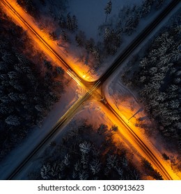 Night Road With Lights Through The Winter Forest Top View From Quad Copter.