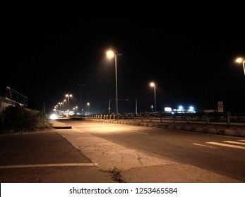 Night road lit with street lamps.