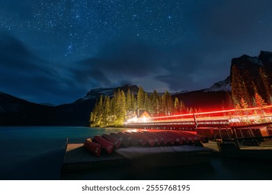 Night scene of Emerald Lake with wooden lodge, starry and canoe surrounding by rocky mountains in Yoho national park, British Columbia, Canada - Powered by Shutterstock