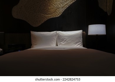 Night scene in hotel room, nightstand with lamp - Shutterstock ID 2242824753